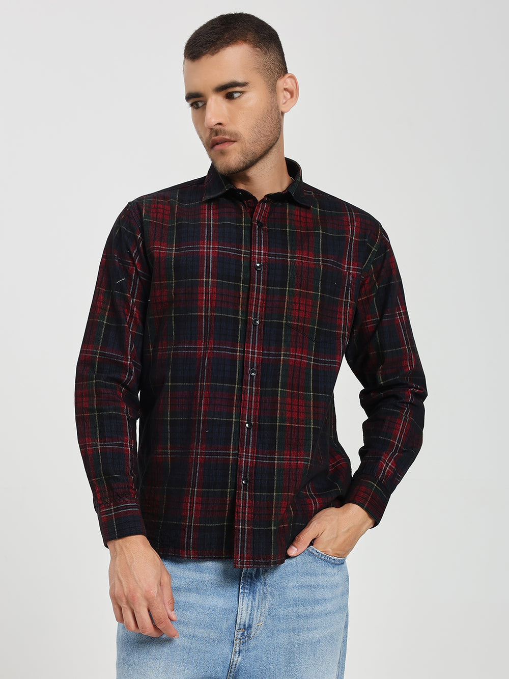 Man wearing a red and black plaid shirt on a white background