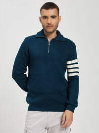 Man wearing a blue sweater with white stripes on a light gray background