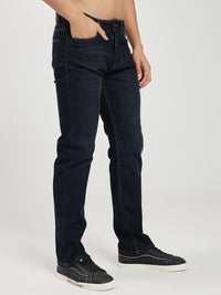 man wearing dark blue jeans on a white background