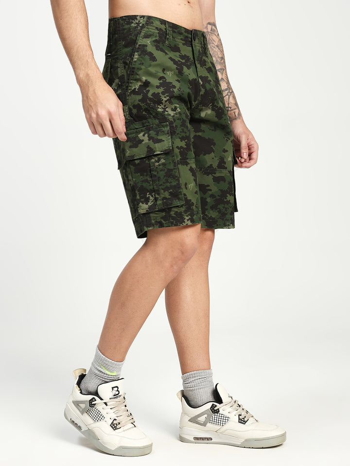 man wearing camouflage cargo shorts on a white background