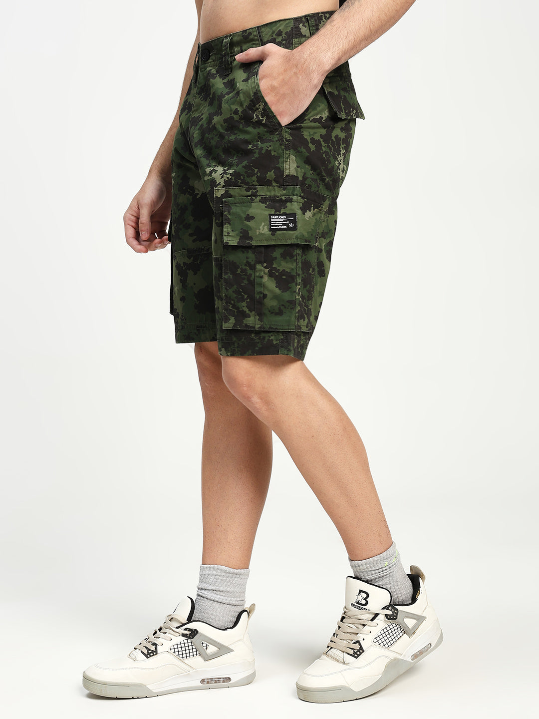 man wearing camouflage cargo shorts on a white background