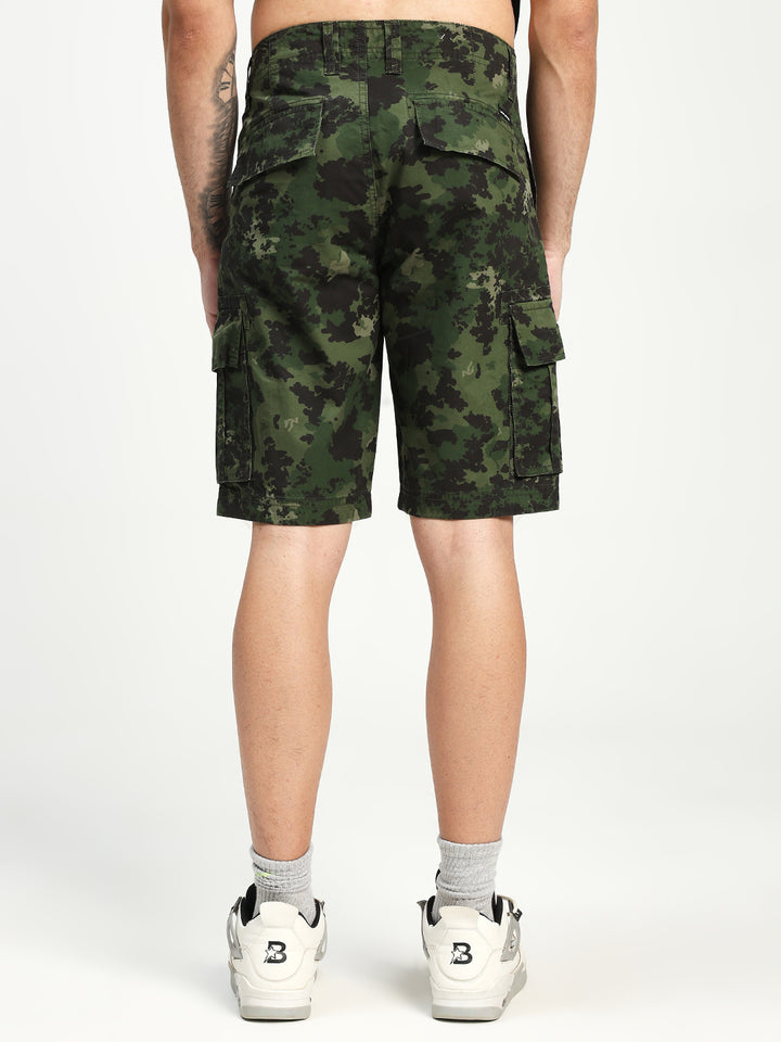 man wearing camouflage cargo shorts on a white background