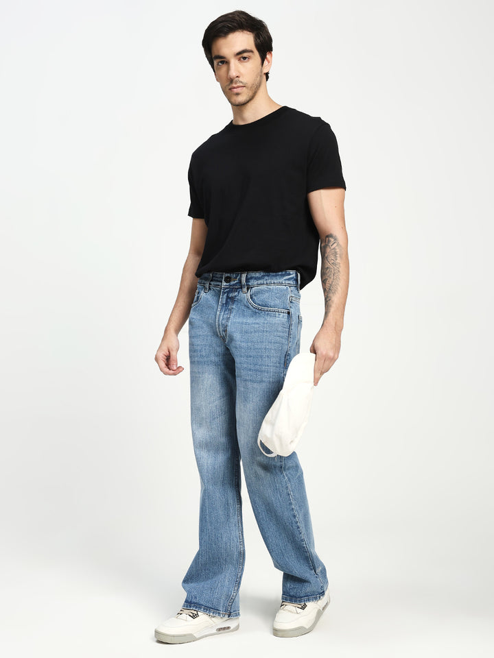 Man Wearing blue bootcut Jeans on white background 
