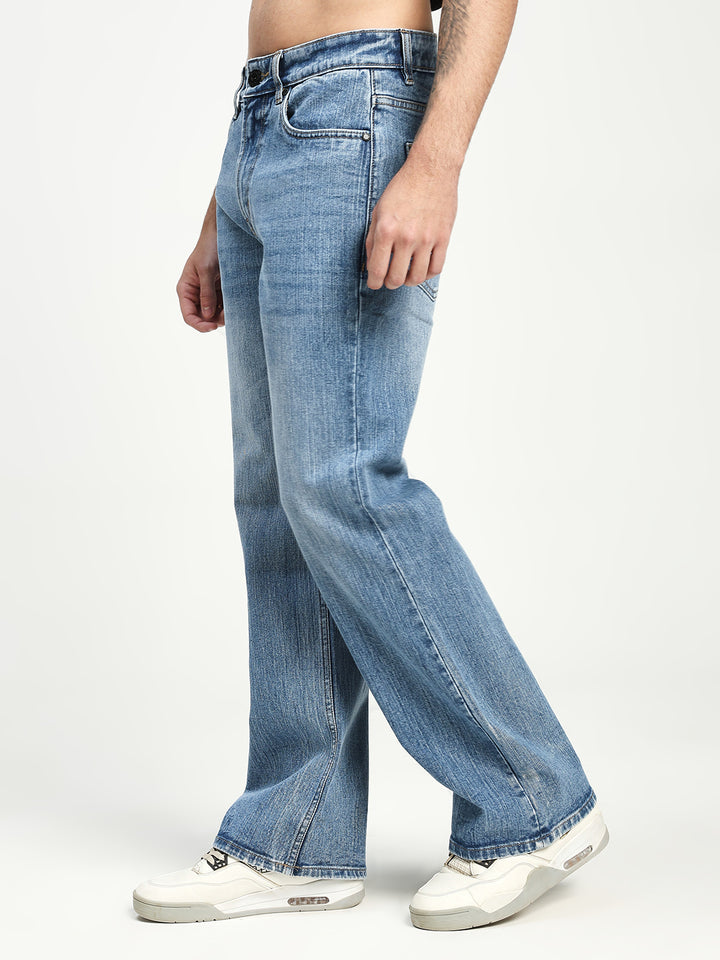 Man Wearing blue bootcut Jeans on white background 
