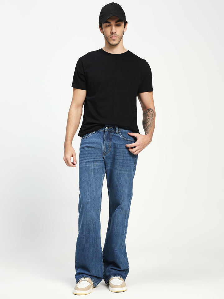Man Wearing blue Bell Bottom Jeans on white background 