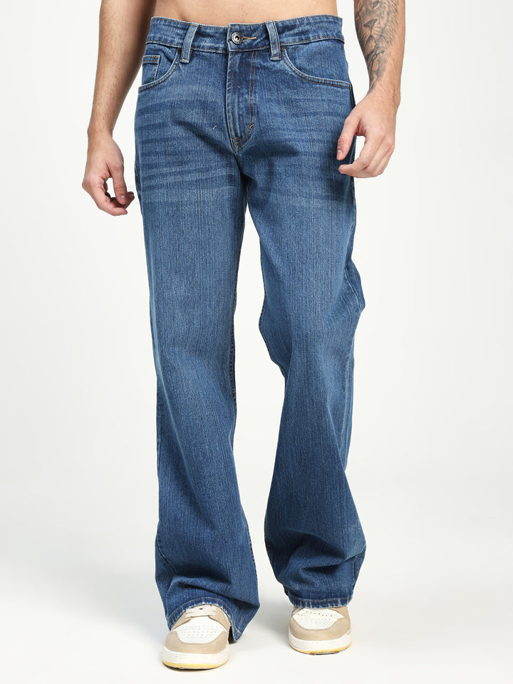 Man Wearing blue Bell Bottom Jeans on white background 