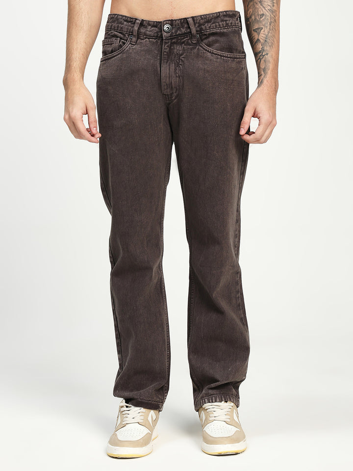 man wearing dark brown ecru eans on a white background 