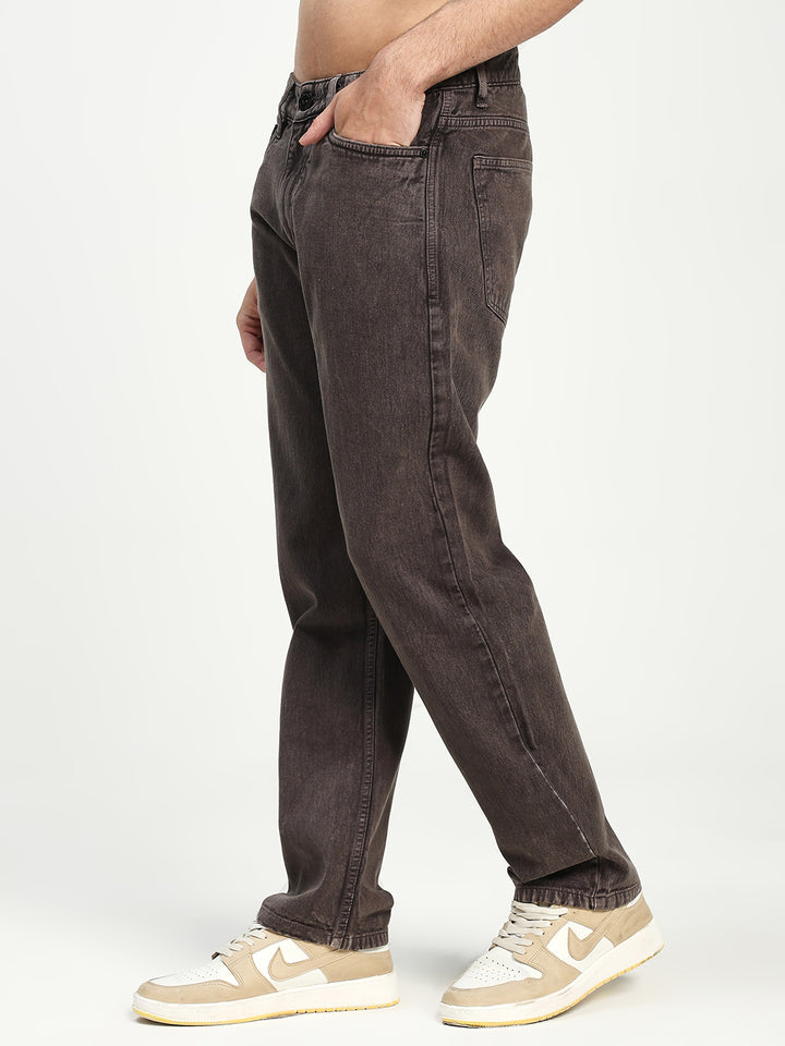 man wearing dark brown ecru jeans on a white background