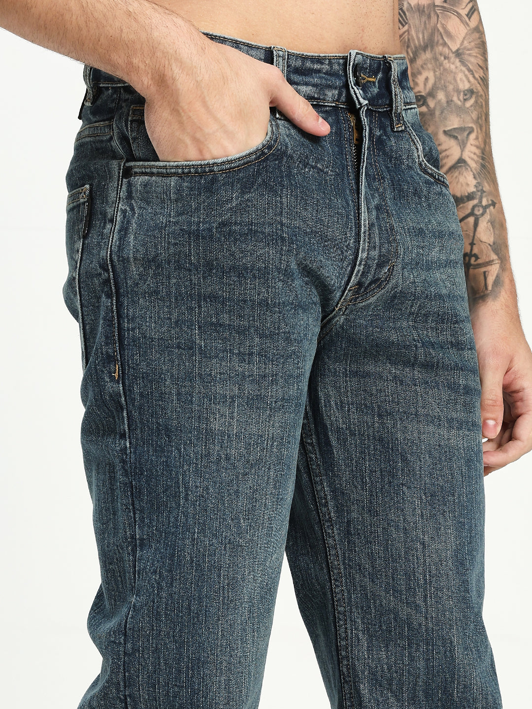 man wearing dark blue bootcut jeans on a white background