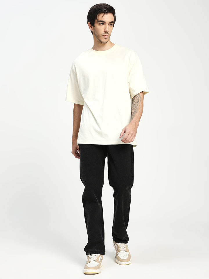 man wearing black ecru jeans on white background 