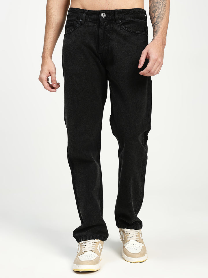 man wearing black ecru jeans on a white background