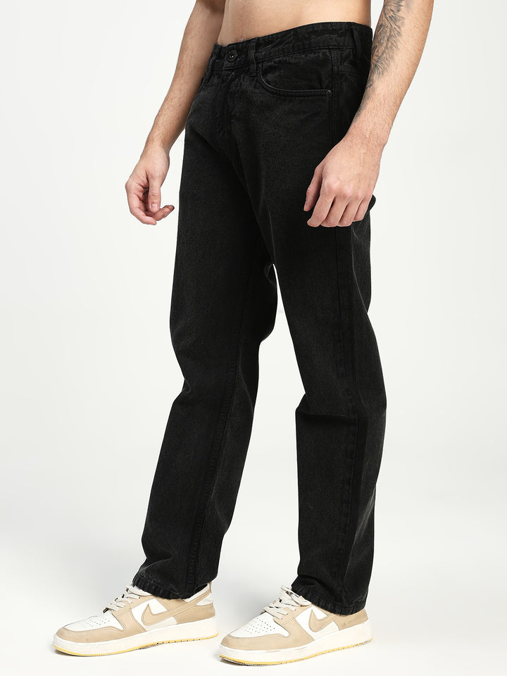 man wearing black ecru jeans on white background 