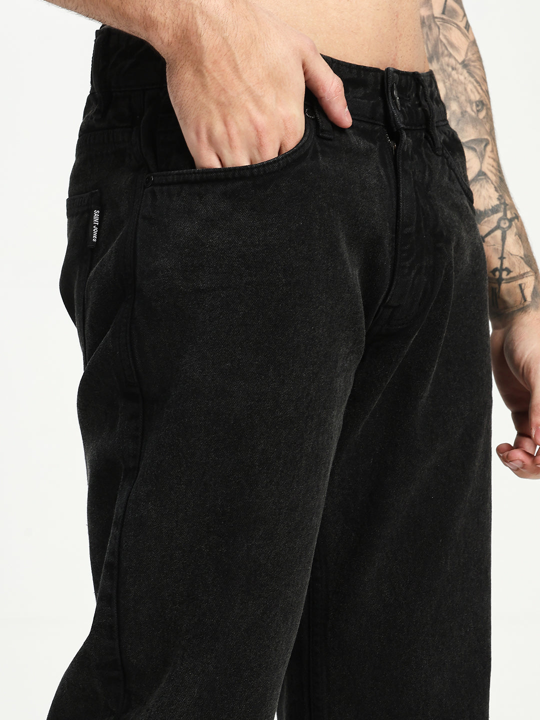 man wearing black ecru jeans on white background 