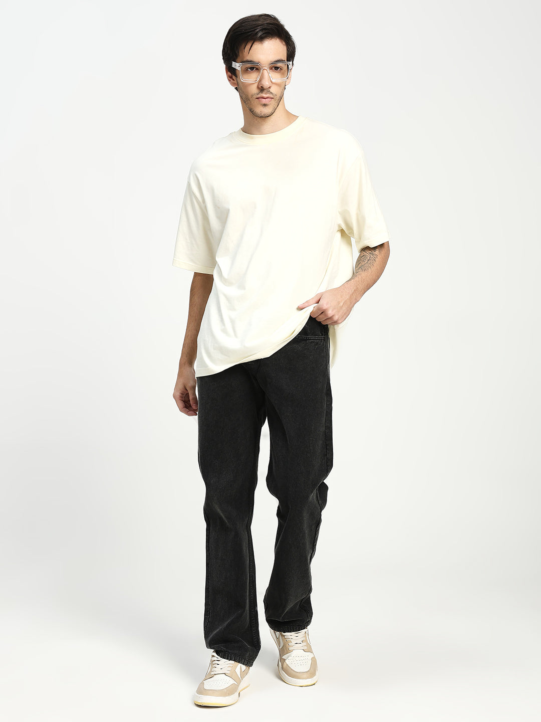 man wearing charcoal acru jeans on white background 