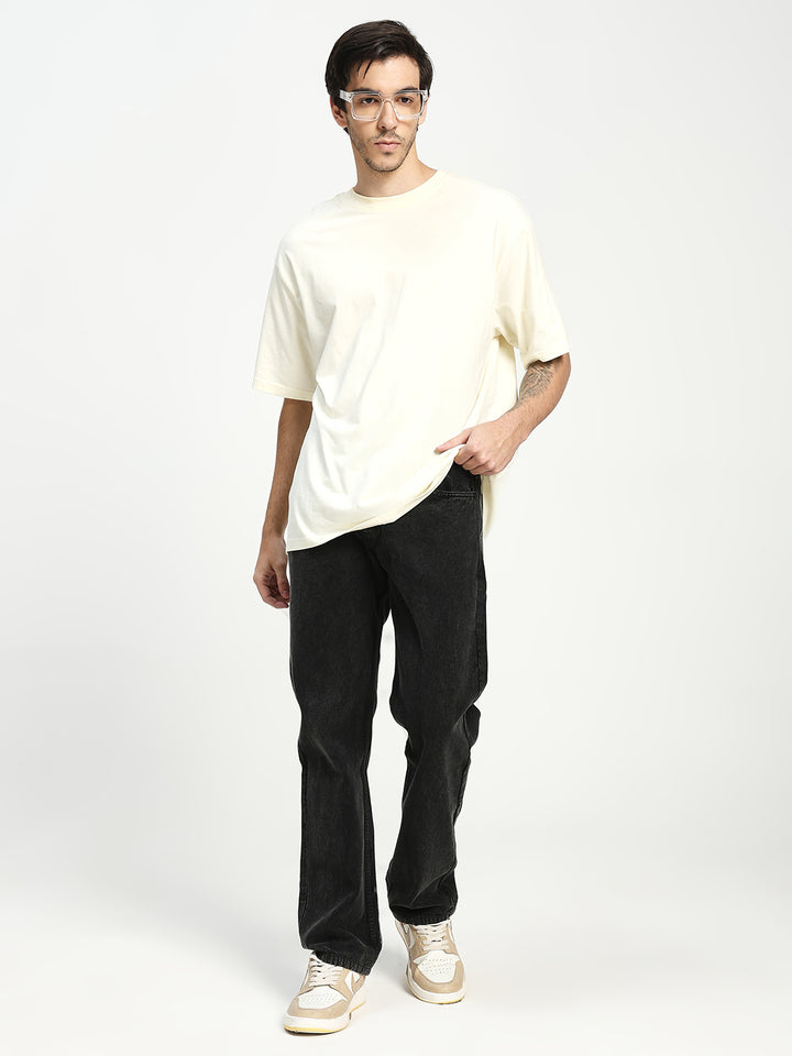 man wearing charcoal acru jeans on white background 