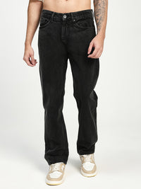 man wearing charcoal acru jeans on white background 