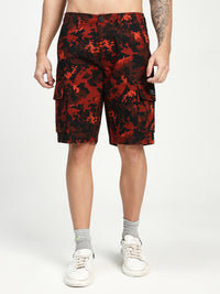 man wearing red and black camouflage cargo shorts on a white background