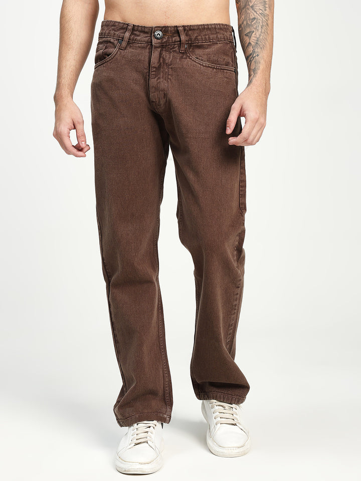 Brown ecru jeans worn by a man  on a white background