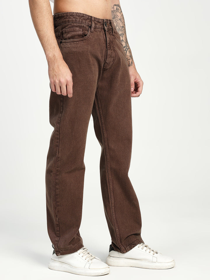Brown ecru jeans worn by a man on a white background