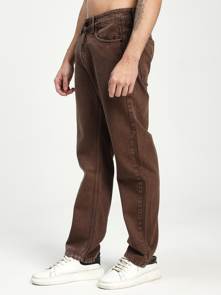 Brown ecru jeans worn by a man on a white background