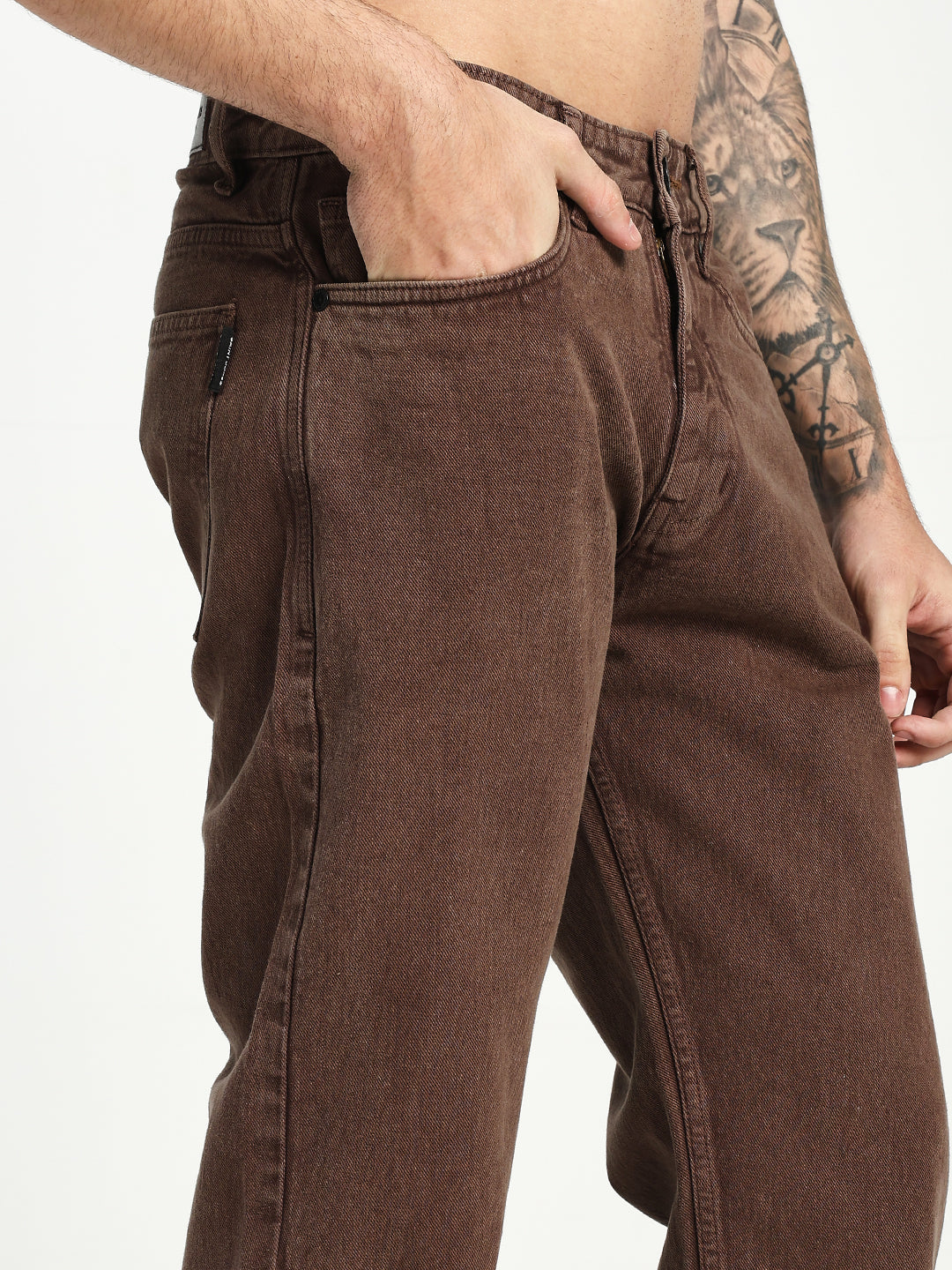 man wearing brown ecru jeans on white background 