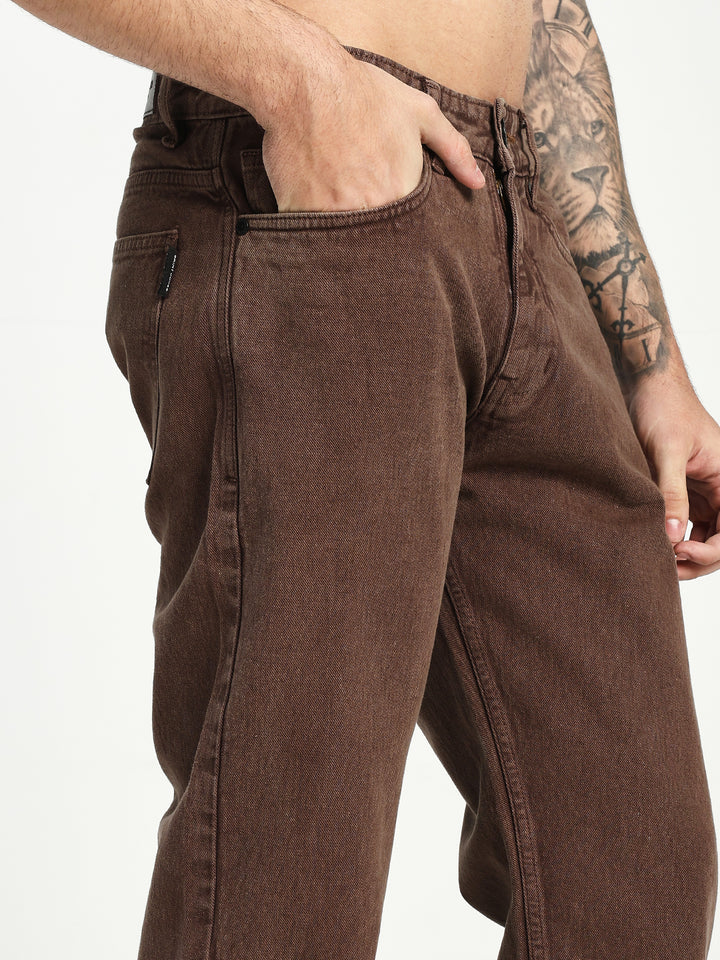 man wearing brown ecru jeans on white background 