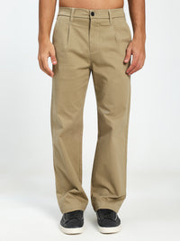 Beige korean pants worn by a man on a white background