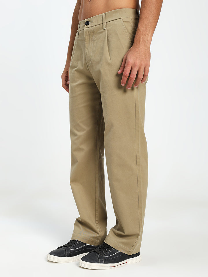 Beige korean pants worn by a person on a white background