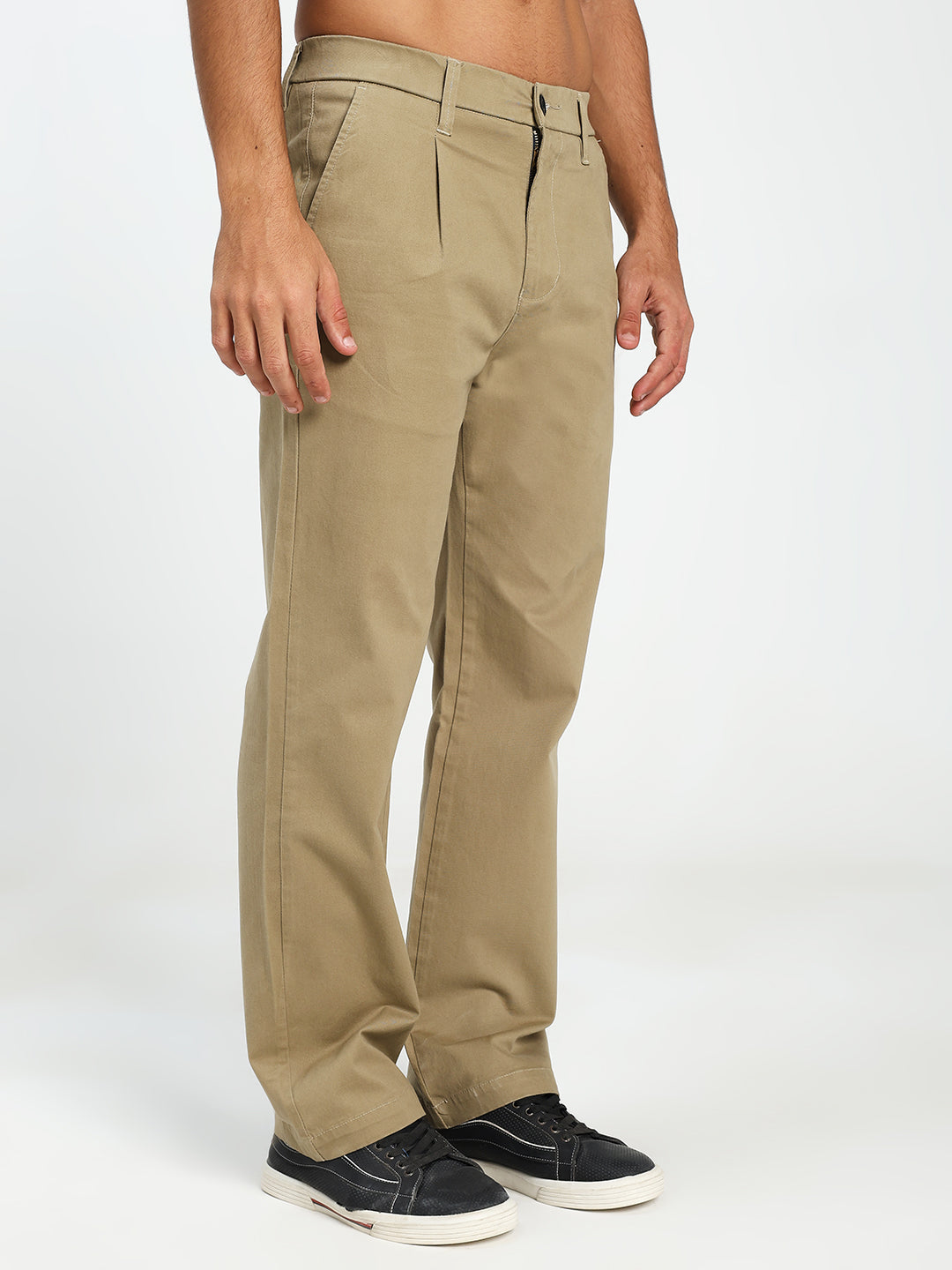 man wearing beige korean pants on a white background