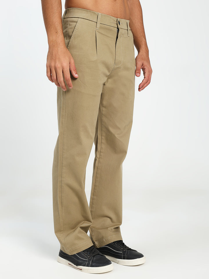 man wearing beige korean pants on a white background