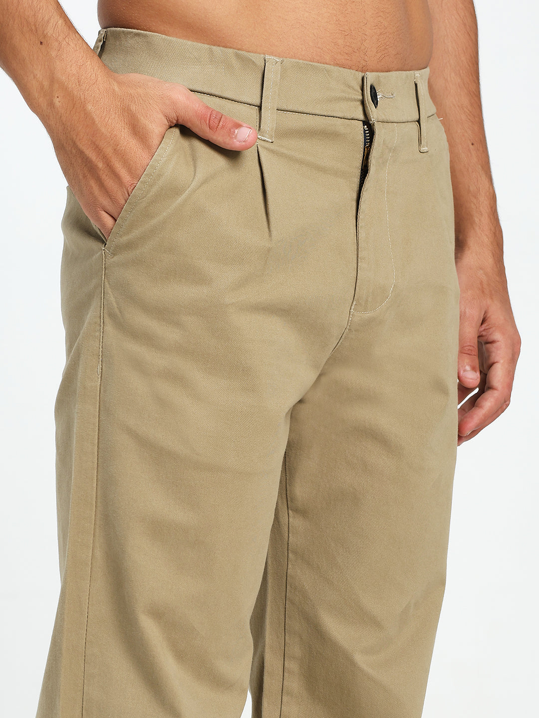 Beige pants worn by a man on a white background