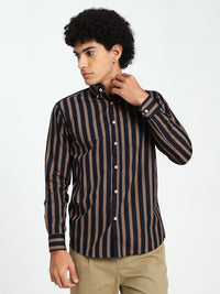 Man wearing a navy blue and brown striped shirt on a white background