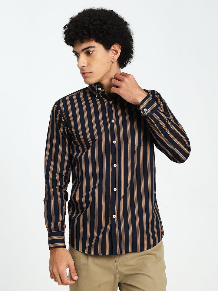 Man wearing a navy blue and brown striped shirt on a white background