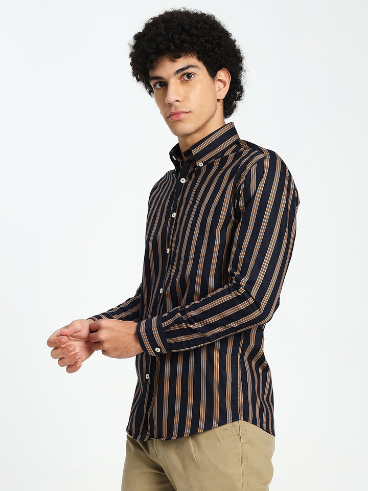 Man wearing a navy blue and brown striped shirt on a white background