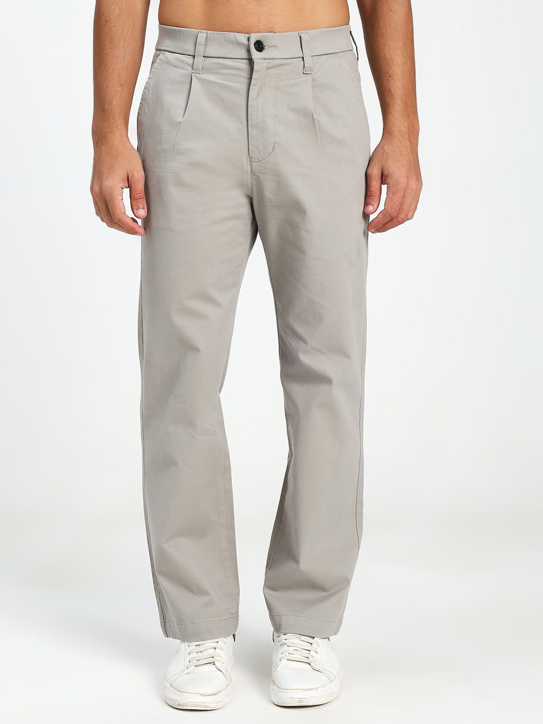 man wearing light gray korean pants on a white background