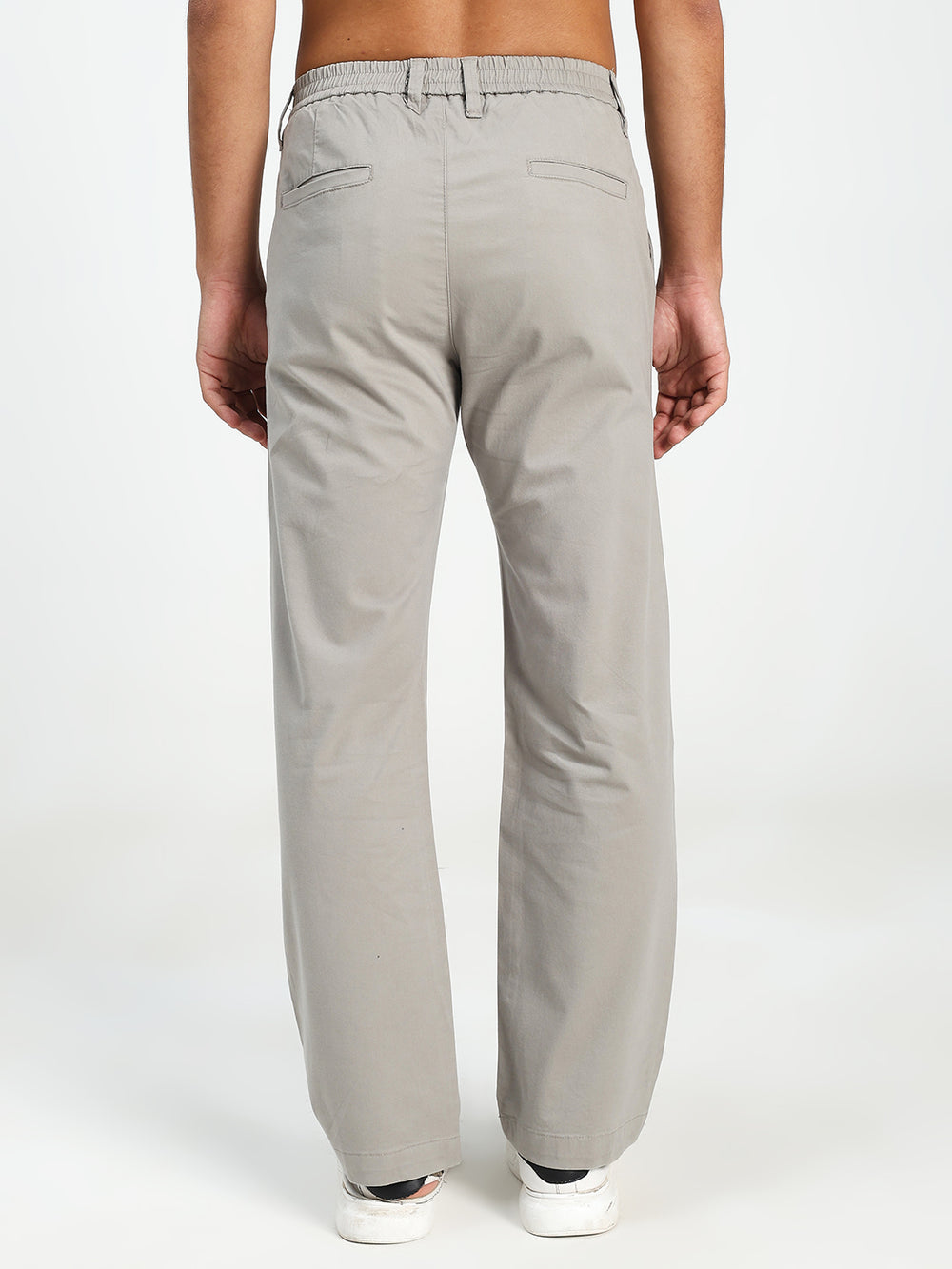 man wearing light gray korean pants on a white background