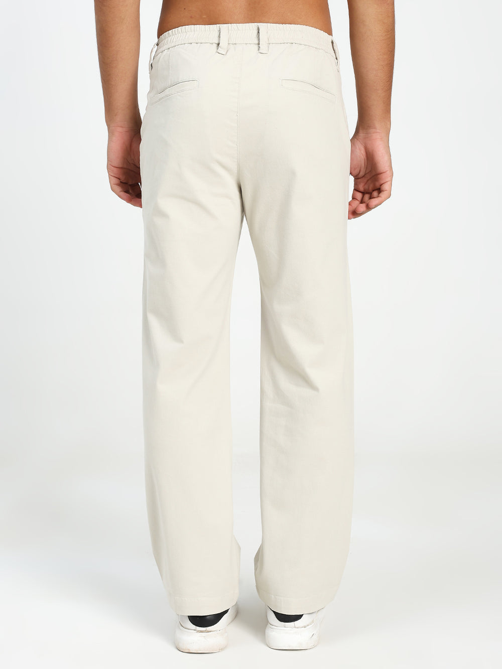 man wearing cream korean pants on a white background