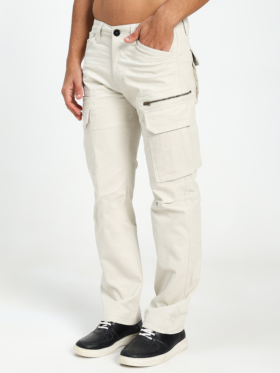 man wearing cream cargo pants on a white background