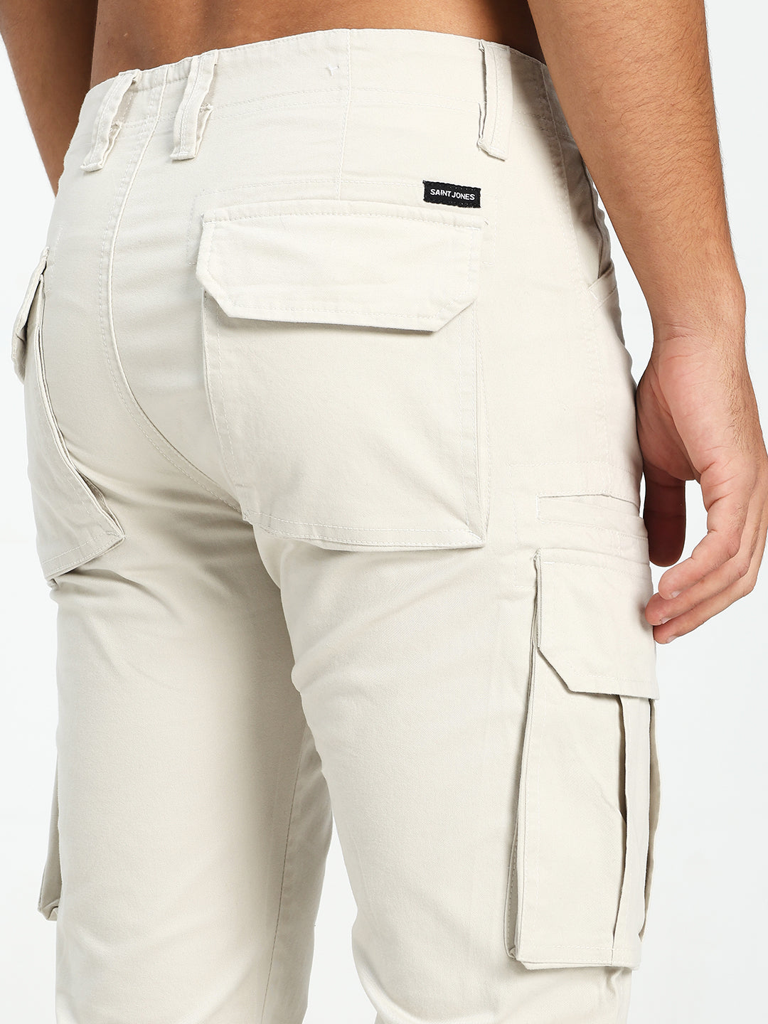 cream cargo pants with a saint jones label on a white background