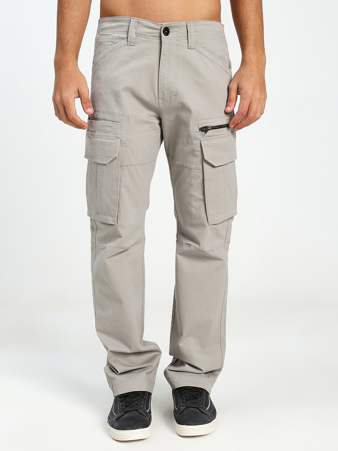 man wearing light gray cargo pants on a white background