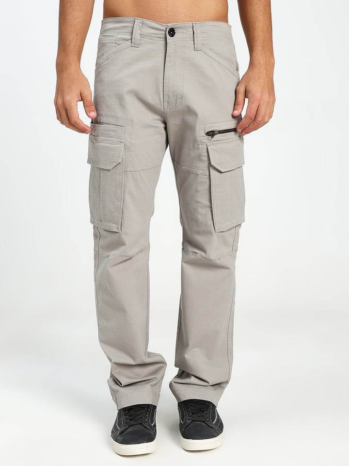 man wearing light gray cargo pants on a white background
