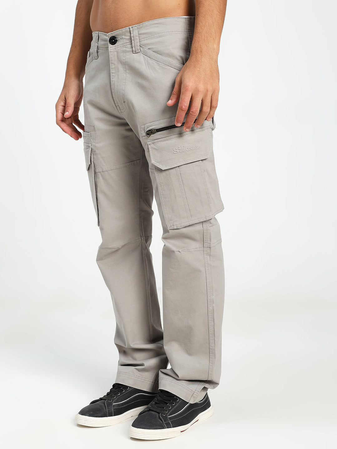 man wearing light gray cargo pants on a white background