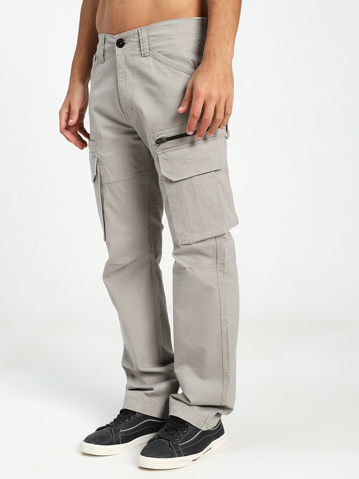 man wearing light gray cargo pants on a white background