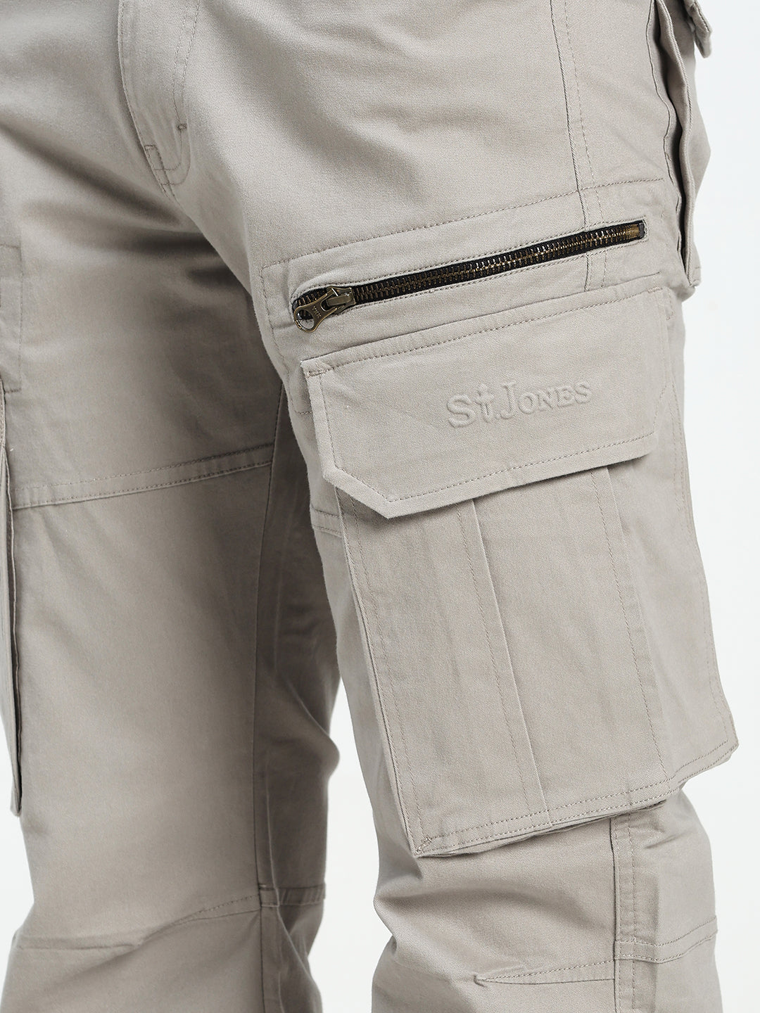 Close-up of grey tactical cargo pants with a visible saint jones logo on a white background