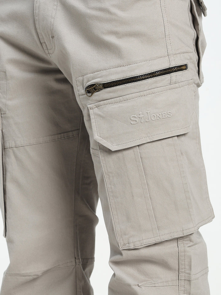 Close-up of grey tactical cargo pants with a visible saint jones logo on a white background