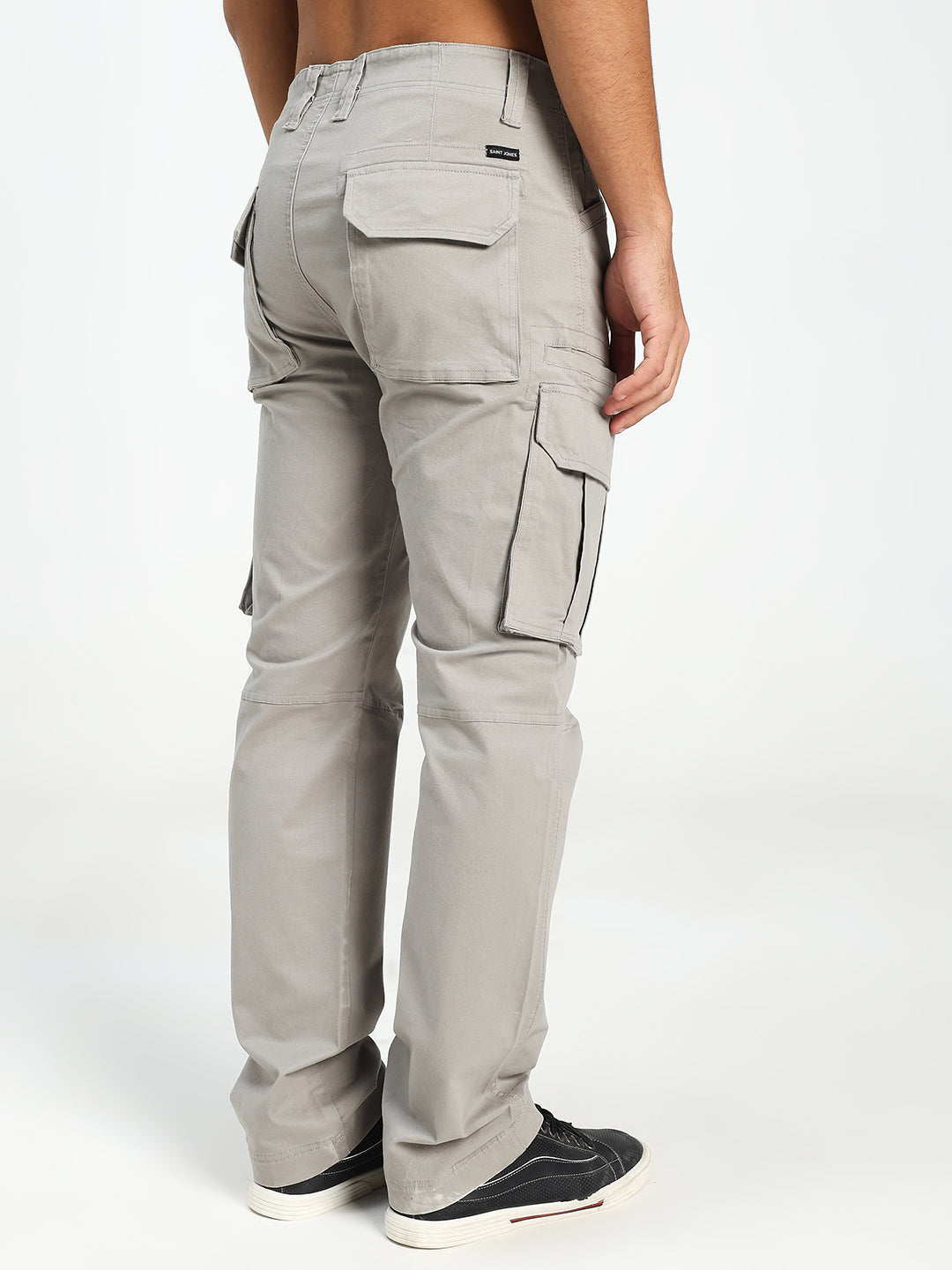 man wearing light gray cargo pants on a white background