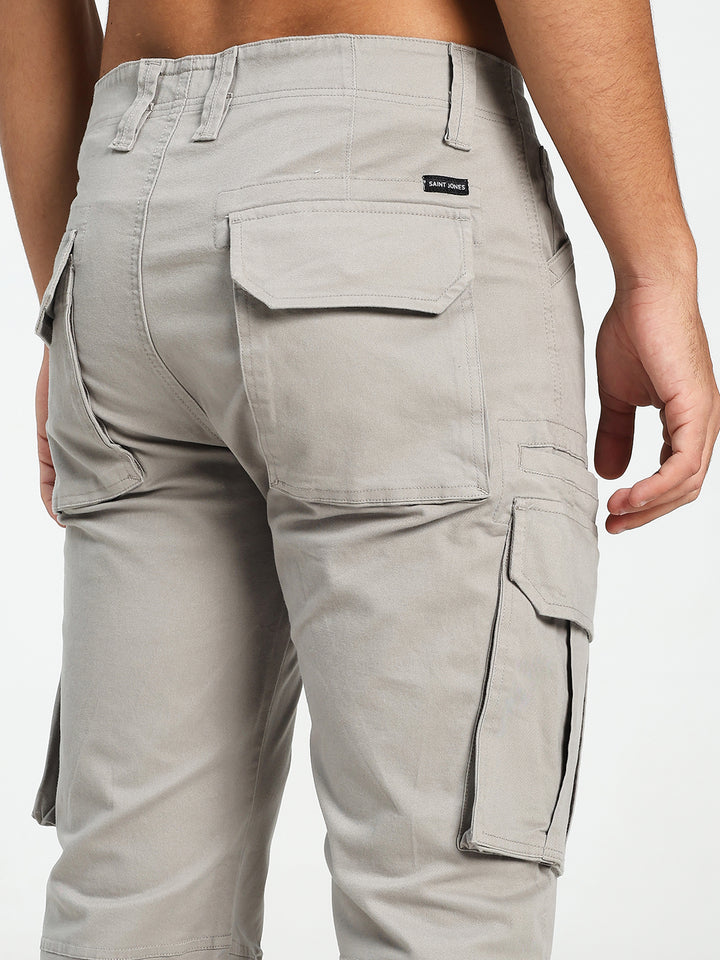 Light gray cargo pants with multiple pockets on a white background