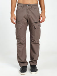 Brown cargo pants worn by a man on a white background