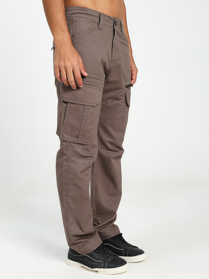 Brown cargo pants worn by a man on a white background