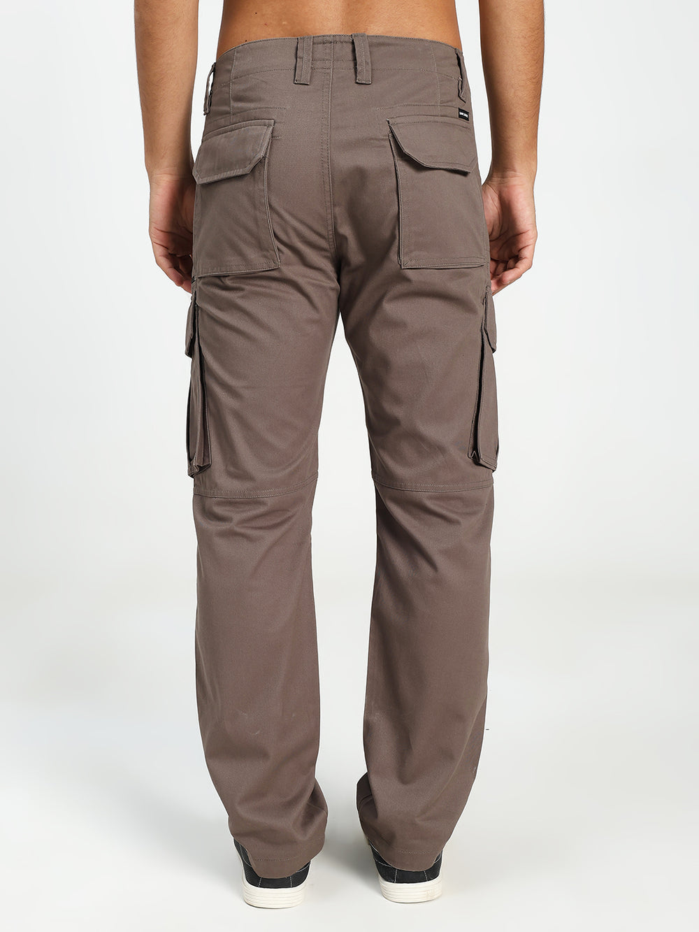 Brown cargo pants worn by a man on a white background